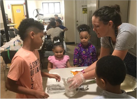 Brass City Harvest staff nutirtionist Nichole Texeira, MPH, teaches children about cooking and nutrition.